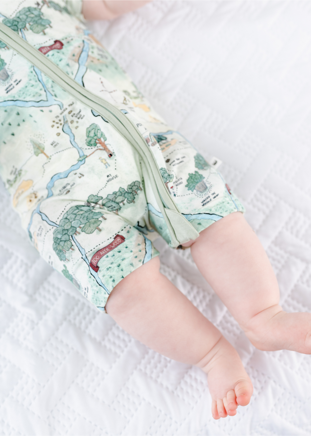 Hundred Acre Woods baby shortie romper. Winnie the Pooh map themed shortie legs.