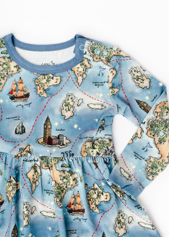 Neverland bamboo long sleeve baby dress close up. Peter Pan Map bamboo long sleeve baby dress close up.