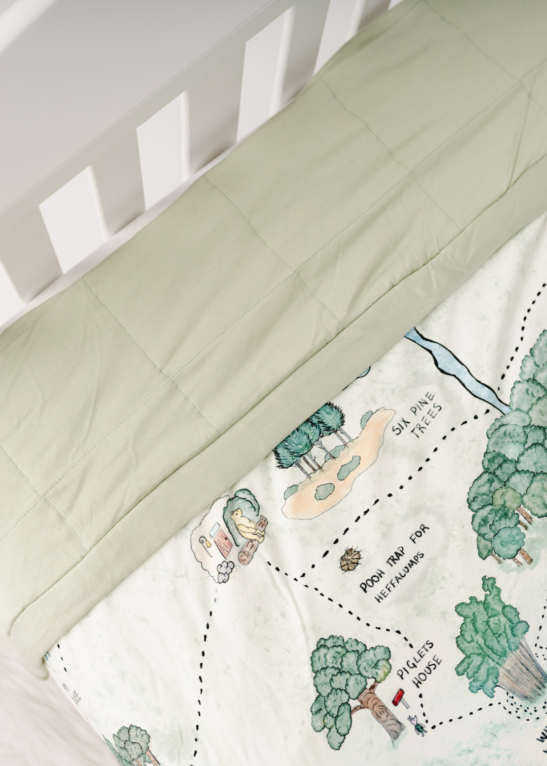 Hundred Acre Woods large bamboo quilt close up with back. Winnie the Pooh map themed large bamboo blanket close up with back.