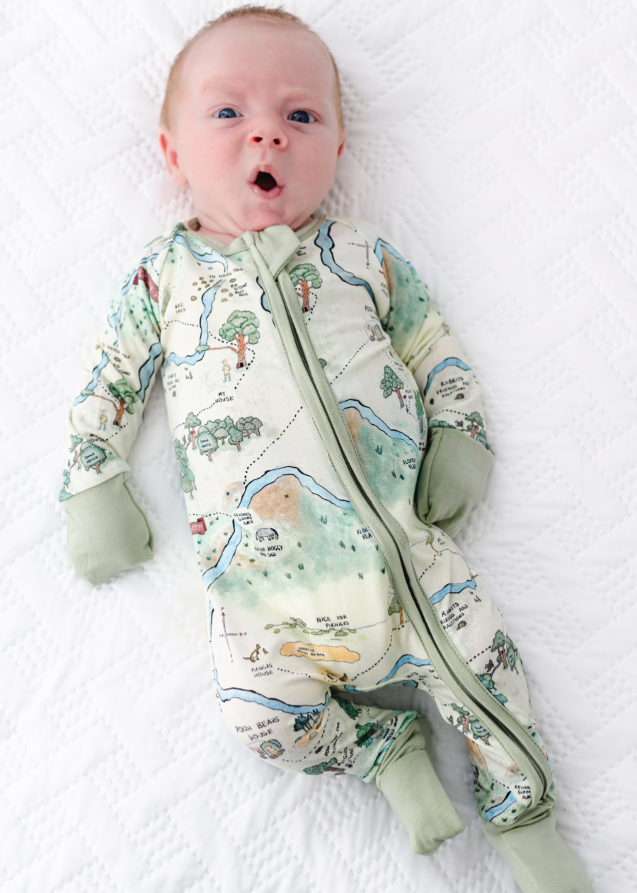 Hundred Acre Woods bamboo baby sleeper. Winnie the Poh map design bamboo zippered sleeper. Model shot