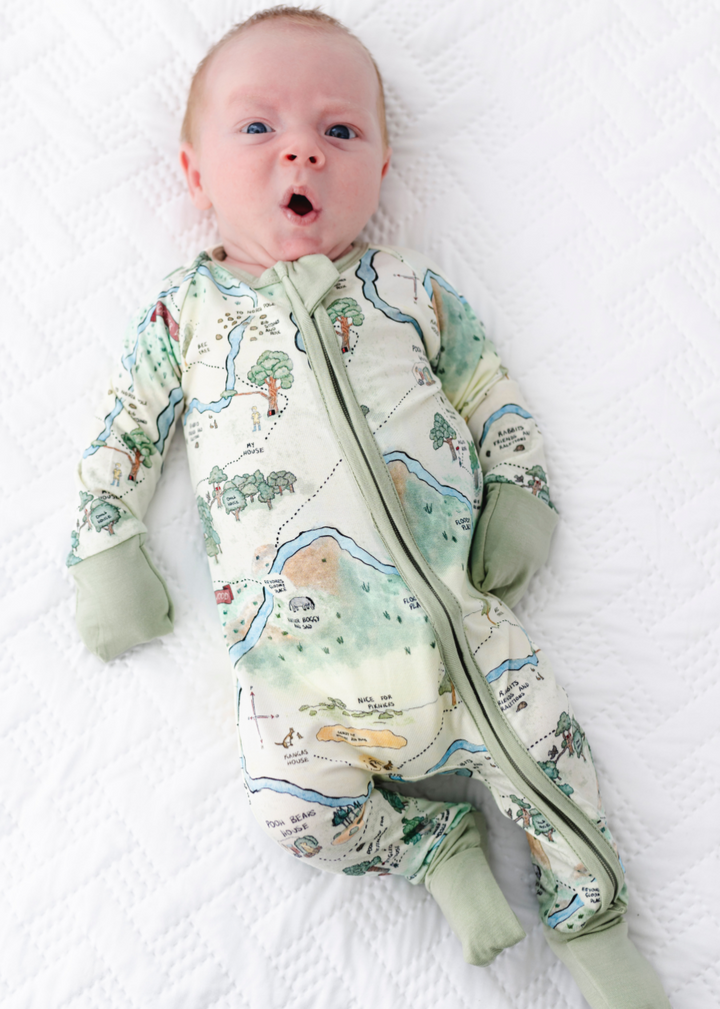 Hundred Acre Woods bamboo baby sleeper. Winnie the Poh map design bamboo zippered sleeper. Model shot