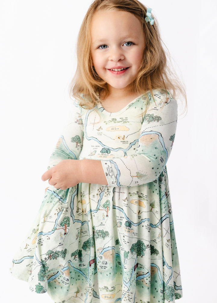 Hundred Acre Woods Winnie the Pooh map design long sleeve twirl dress with matching shorts. Model shot 