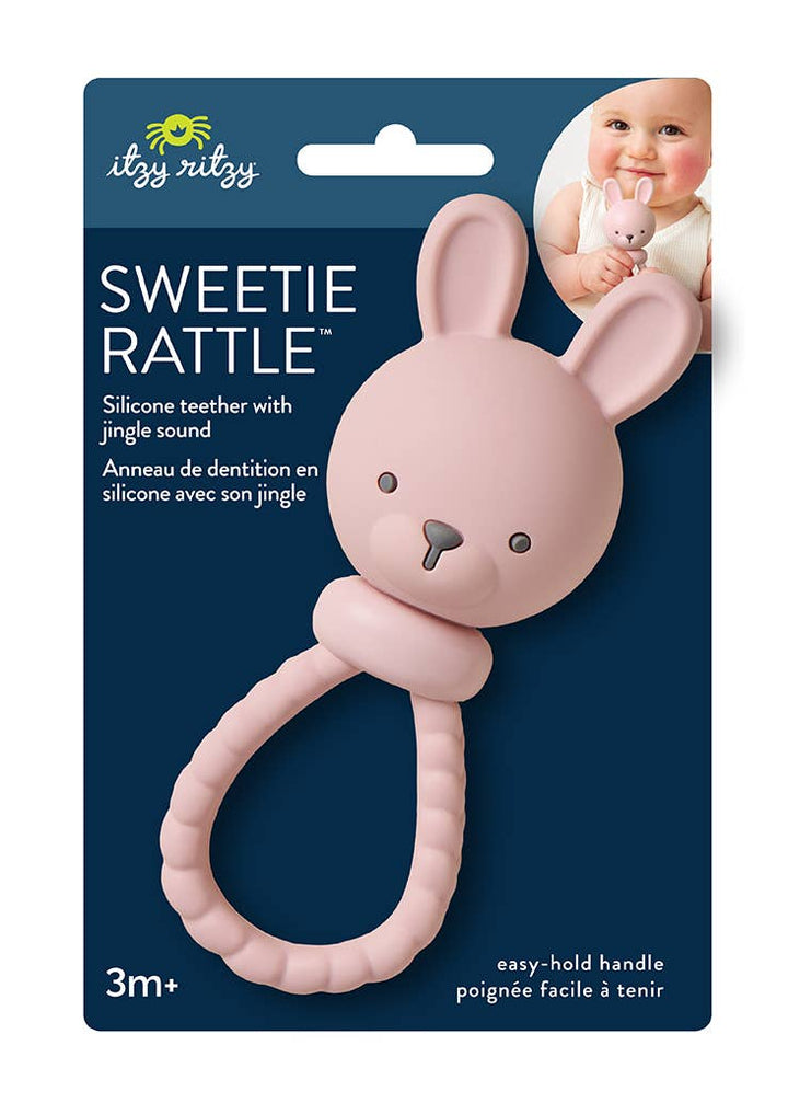 Pink bunny rattle with packaging on a white background