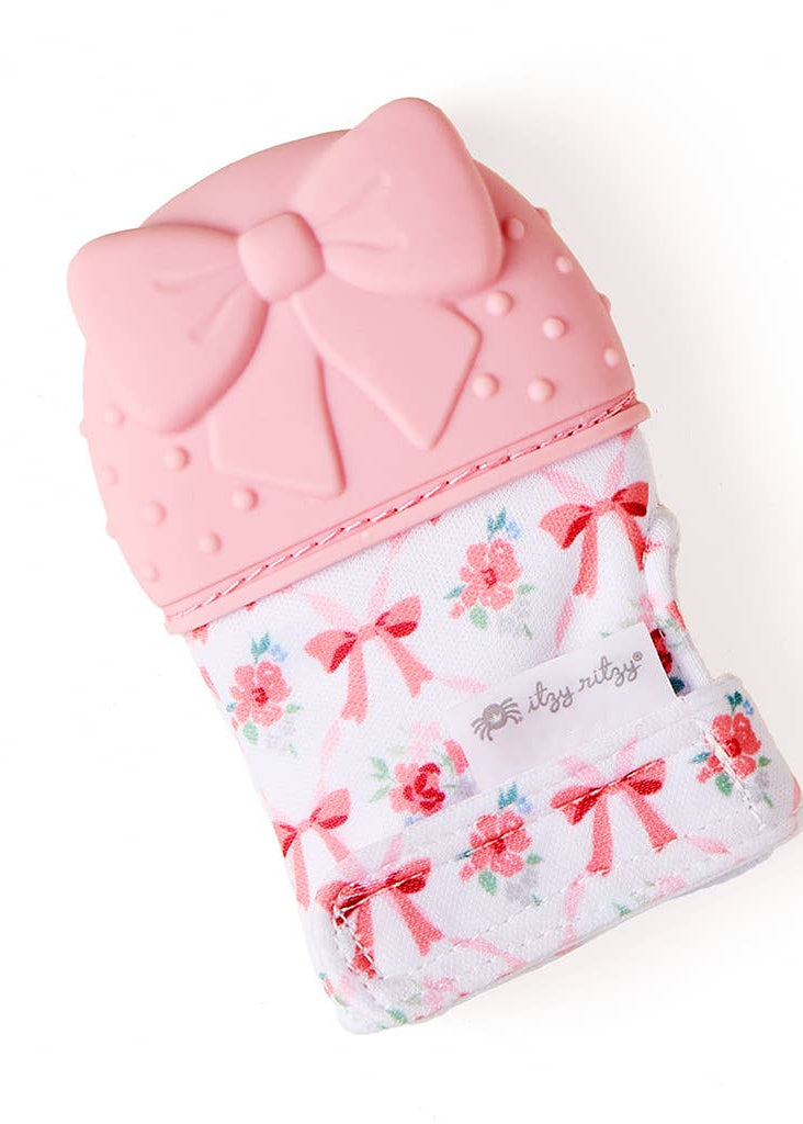 Pink baby teether with floral and bow pattern 