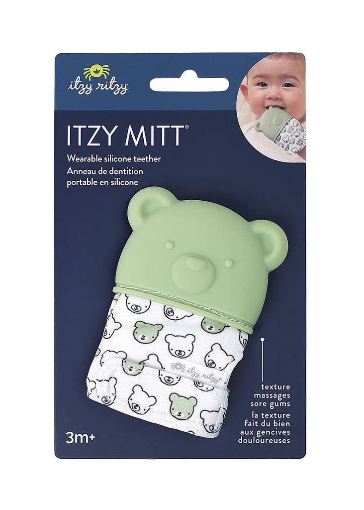 Green silicone teether with bear design on a blue packaging background