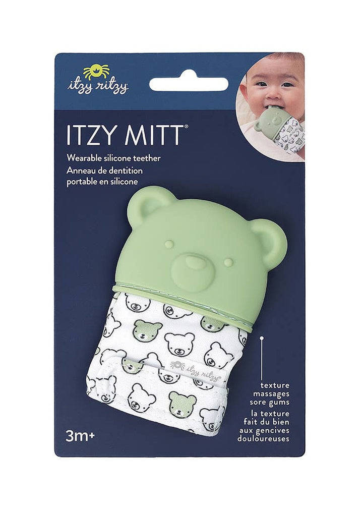 Green silicone teether with bear design on a blue packaging background